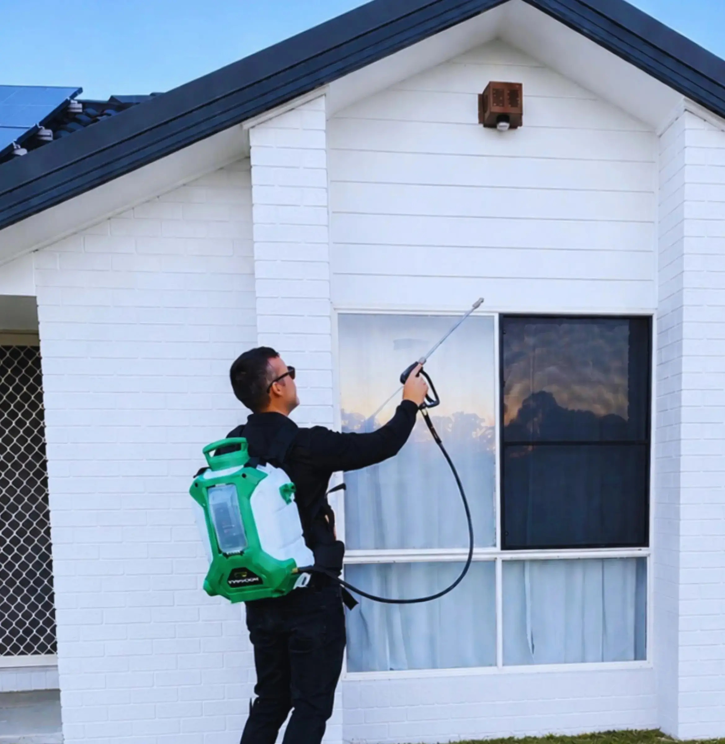 Urban Pest technician treating a home exterior